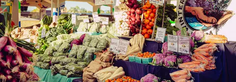 A colorful display of fresh vegetables at a market stall.