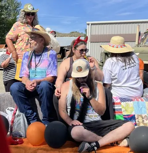 A group of people relaxing together outdoors on a sunny day.