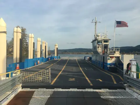 A view of the car deck of a ferry boat at a dock.
