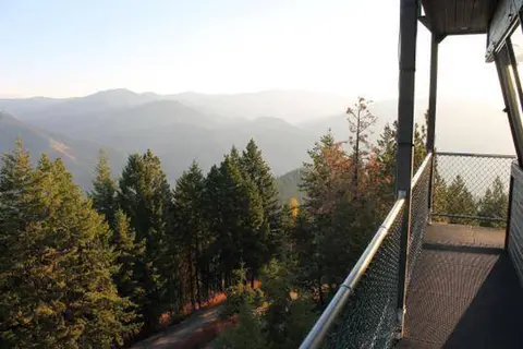 A view of forested mountains from a high balcony.