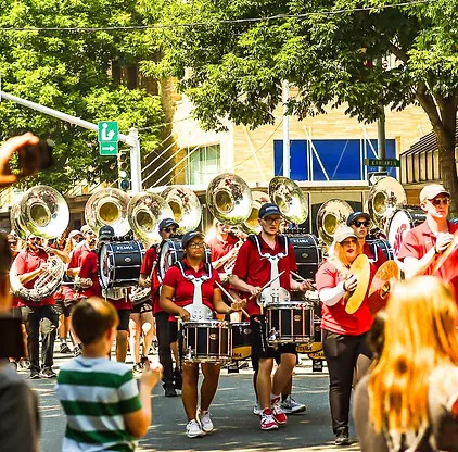 A marching band performs in a street parade.
