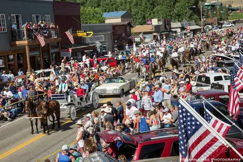 A crowd of people celebrating a parade on a town street.