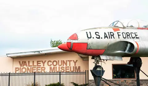 An airplane with U.S. Air Force markings is displayed outside a building.