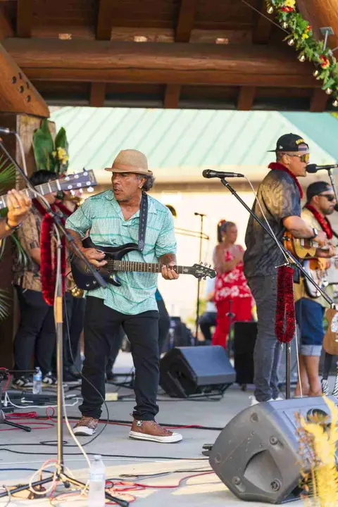 A band playing music on an outdoor stage.