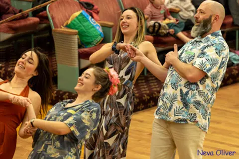 People dance together indoors.
