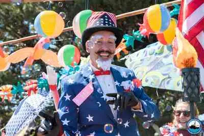 A person dressed in a patriotic suit and top hat at a parade.