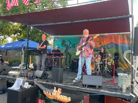 A band performs on an outdoor stage.