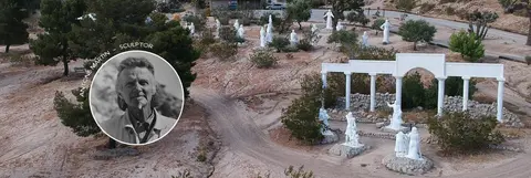 An aerial view of an outdoor sculpture park featuring white figures and structures.