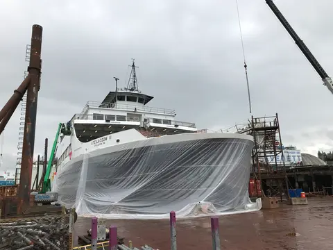A ferry undergoing work in a shipyard.