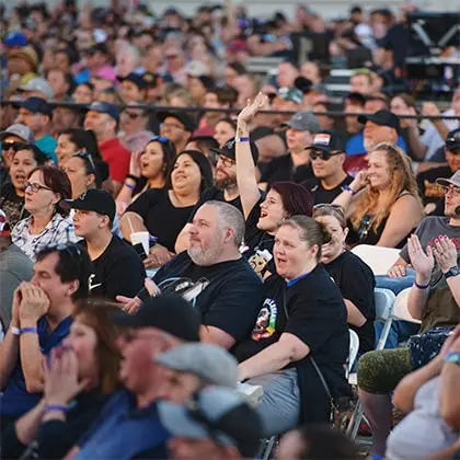 A large crowd of people watching an event.