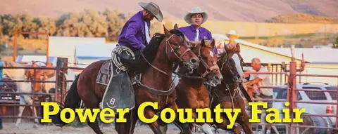 People ride horses at an outdoor fair.