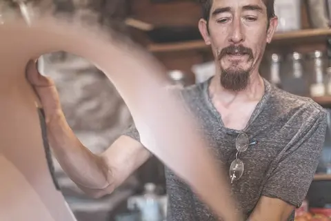 A man working indoors with motion blur in the foreground.