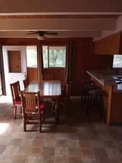 An interior view of a dining room with wooden furniture and paneled walls.