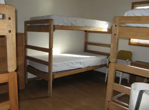 A bedroom furnished with wooden bunk beds.
