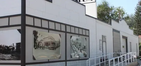 Exterior view of a building with historical photographs mounted on the wall.