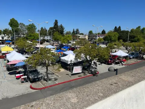 An outdoor flea market or swap meet held in a parking lot.