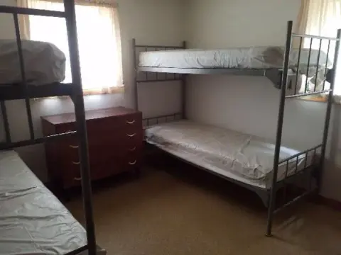 A bedroom with bunk beds and a dresser.