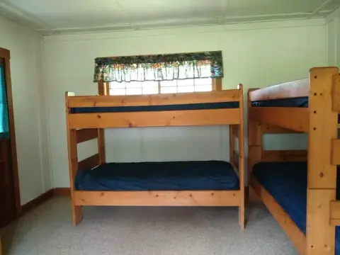 Interior view of a room with wooden bunk beds.
