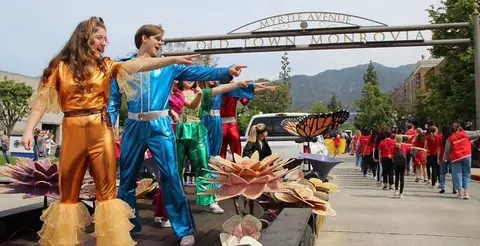 People in costumes on a float during a parade.