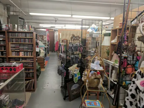 An interior view of a store filled with shelves, displays, and merchandise.