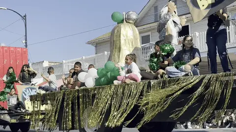 People riding on a decorated parade float.
