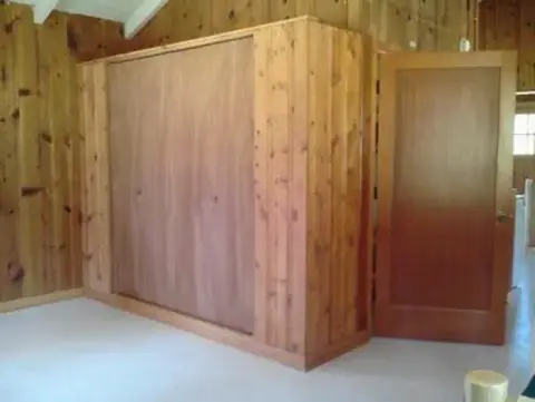 An interior view showing wood-paneled walls and doors.