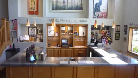 An interior view of a tasting room with wooden bars and displays.
