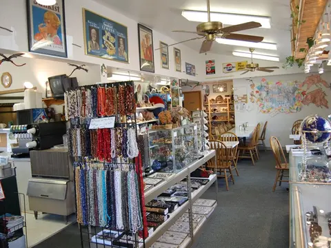 An interior view of a store displaying various beaded necklaces, crystals, and other merchandise.