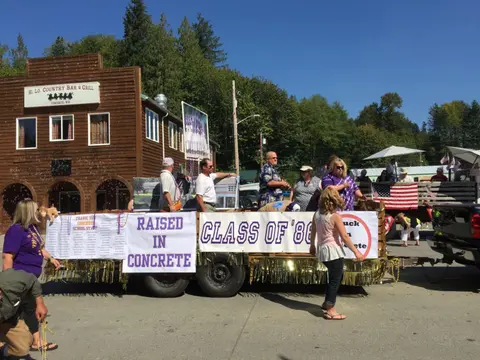 A parade float with people on it during a community event.
