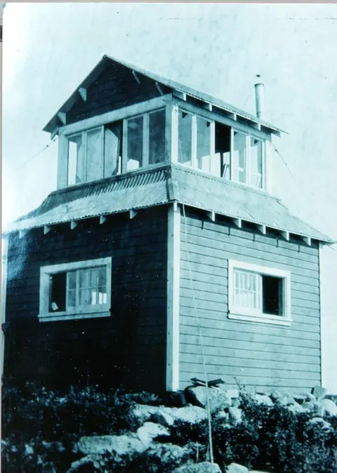 An old photograph showing the exterior of a two-story lookout tower.