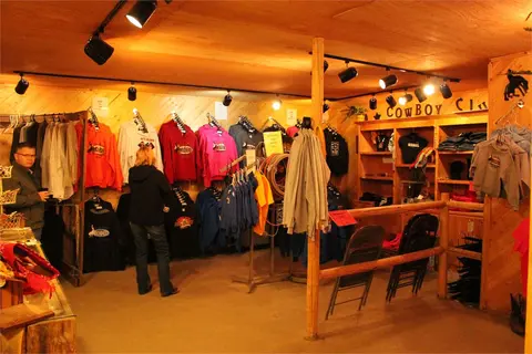 An interior view of a store displaying clothing and apparel.