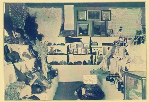 An old black and white photo shows an indoor display with various items.