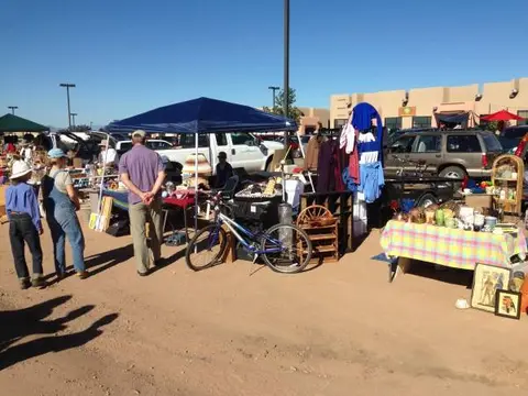 People browsing stalls at an outdoor flea market.
