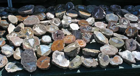 A collection of sliced and polished geodes displayed on a table.