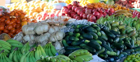A colorful display of various fresh fruits and vegetables at a market.