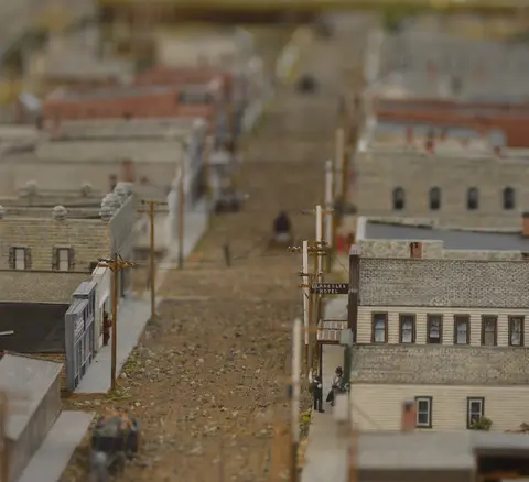A detailed model of a historic town street with miniature buildings.