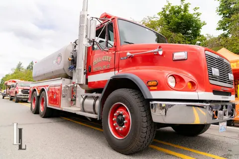 A red fire tender truck parked on a street.