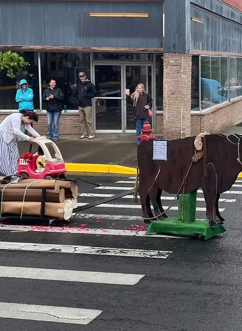 People watching a parade float on a city street.