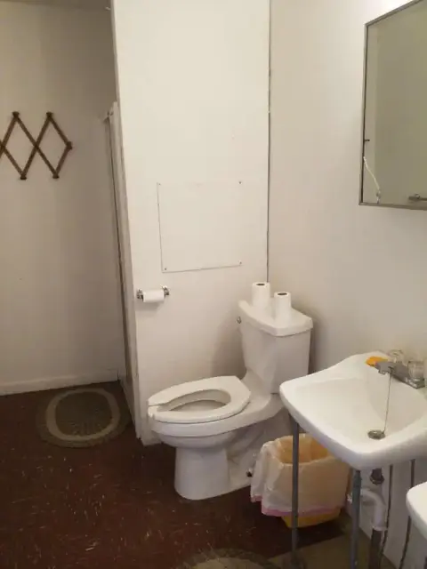 A simple bathroom with a toilet and sink.