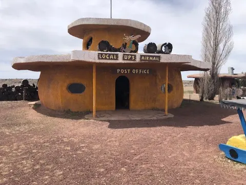 A unique post office building styled like a prehistoric stone structure.