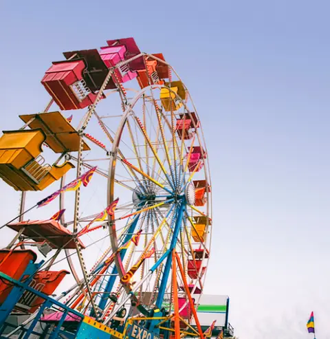 A colorful ferris wheel against a clear sky.