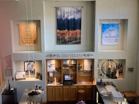 An interior view of a tasting room with a bar and wall niches.