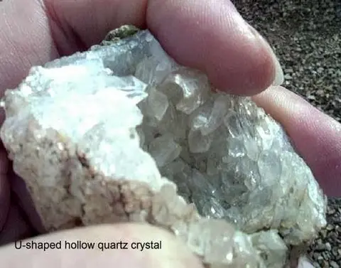 A person holding a quartz crystal geode.