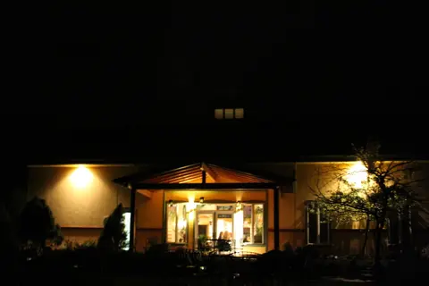 An illuminated building exterior at night.