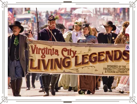 People in historical costumes carry a banner during a parade outdoors.