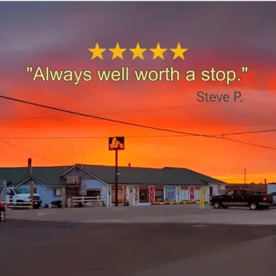 A sunset sky over a single-story building with a parking lot and overlay text.
