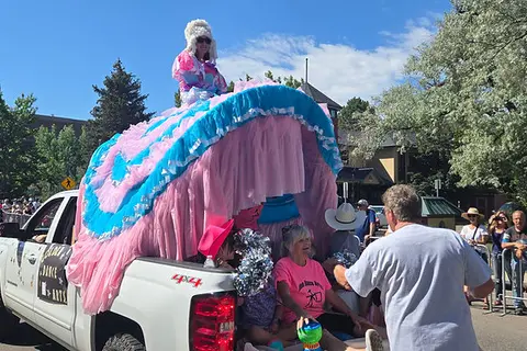 A decorated parade float in the bed of a pickup truck.