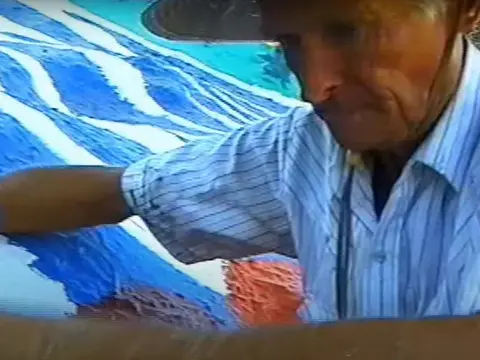 A person working on a craft or painting.