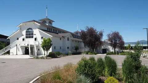 Exterior view of a large white historic building under a clear blue sky.