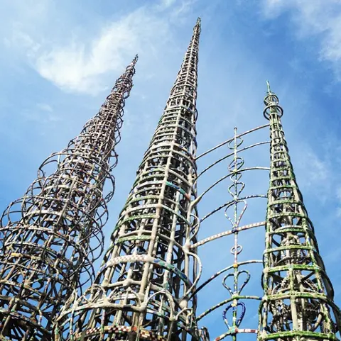 Low-angle view of tall towers made of structural steel and concrete decorated with tile.